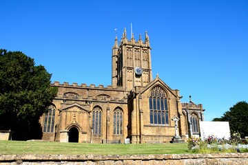 Front view of St Marys Minster Church in the town centre with the graveyard in the foreground, Ilminster, Somerset, UK, Europe. - 734962448