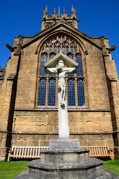Front view of St Marys Minster Church in the town centre with the war memorial and crucifix in the foreground, Ilminster, Somerset, UK, Europe.