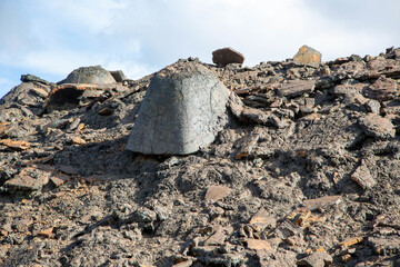 Metallurgical waste and slag against the blue sky.