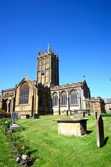 Front view of St Marys Minster Church in the town centre with the graveyard in the foreground, Ilminster, Somerset, UK, Europe.