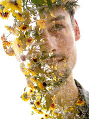 A double exposure portrait of a young man combined with yellow flowers - 734963607