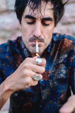 Man lighting a cigarette with a lighter
