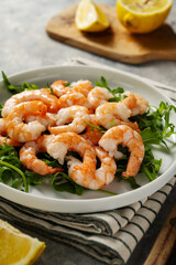 Cooked shrimps in a plate, seafood, bright background. 
