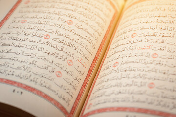 Quran (Koran) - close up of holy book of Muslims, with shining light.