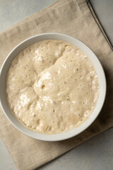 Top view sourdough starter in a bowl. Home baking, wild east, fermented food.