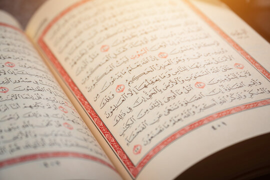 Quran (Koran) - close up of holy book of Muslims, with shining light.