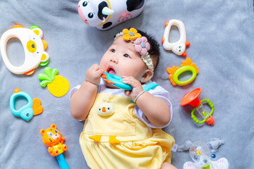 Fototapeta na wymiar Baby in cute outfit with toys,Little girl 3-6 months old in cute outfits