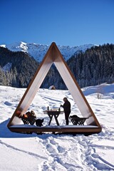 Wooden gazebo in the snowy mountains on the winter holiday hike