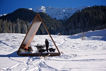 Wooden gazebo in the snowy mountains on the winter holiday hike