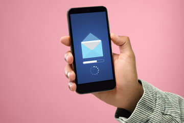 Got new message. Man using smartphone on pink background, closeup