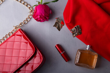 Essentials with perfume and lipstick for a sophisticated look among roses