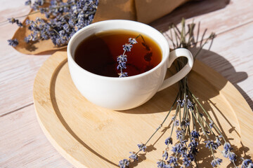 White cup of lavender tea. Mortars of dry lavender alternative medicine. Immunity boosting healthy...