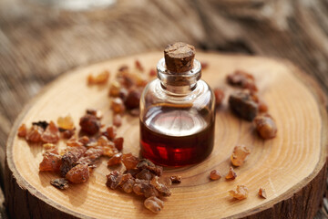 A bottle of myrrh essential oil with myrrh resin