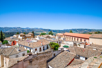 Fototapeta na wymiar Ronda ind Andalusia, Spain. View from above on the touristic city, houses and roofs.