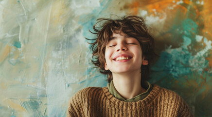 Smilling Boy on wall background. Happy teen banner