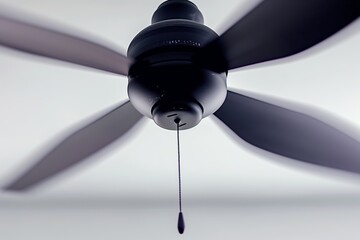 ceiling fan spinning with blades blurred from motion