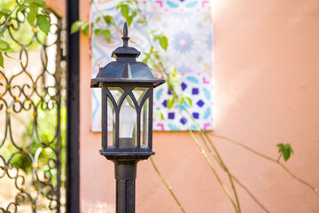 Vintage style outdoor garden lamp over blurred background, outdoor day light, garden decoration object