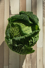 Closeup of green fresh organic savoy cabbage on table