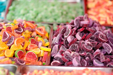 A lot of colors gummy, jelly, toffee, fudge, caramel and chocolate candies are selling in shop....