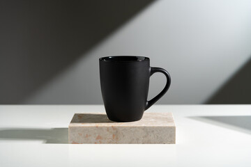 Black cup shadow sun light against gray background