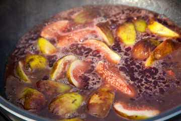 boiling fruits with wine in the pot