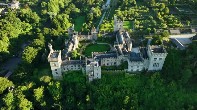 Irish castle by the river on a green hill in 4k