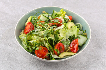 salad with tomatoes and cucumbers on a stone background, studio food photography 1