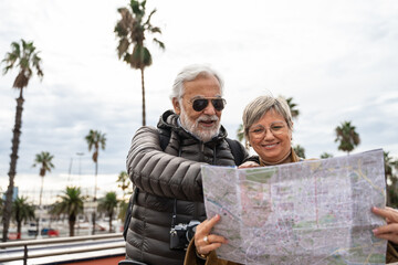 Happy senior couple enjoying retirement tourist trip, visiting city on spring vacations