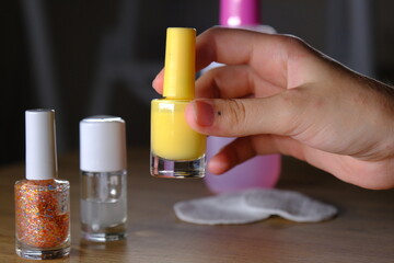 woman holding colorful nail polishes
