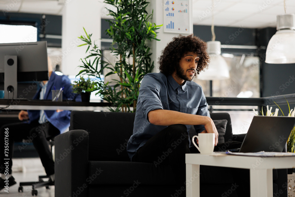 Aufkleber company arab executive manager researching on laptop while working in business workspace. businessma