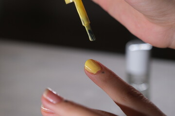 woman applying nail polish to her nails