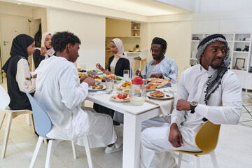 A traditional and diverse Muslim family comes together to share a delicious iftar meal during the sacred month of Ramadan, embodying the essence of familial joy, cultural richness, and spiritual unity