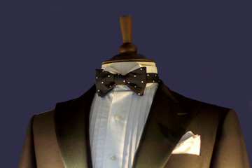 black tailcoat with a white shirt and a black bowtie on a mannequin close-up
