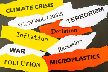 Current affairs, sheets of various colors with words: economic crisis, war, inflation, terrorism, etc., on a black background.

