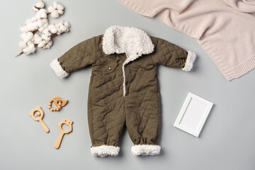 Gray quilted baby overalls for winter flat lay - obrazy, fototapety, plakaty