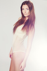 Obraz premium Woman, portrait and lingerie with fashion in studio for healthy body, calm expression and wellness on white background. Model, person or confidence with red hair, pride and underwear for femininity