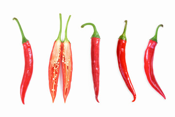 Red hot chili peppers. Chili pepper sliced, cross section. Four red long hot peppers and one chilli pepper sliced in half