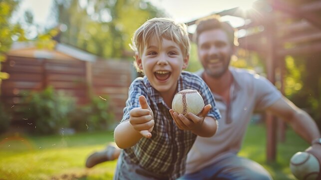 Father and son enjoy a playful baseball game in their garden at sunset.
