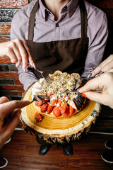 Person Cutting Into a Cake With a Knife and Fork