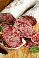raw smoked sausage sliced on a wooden board