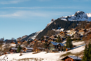 The Bernese Alps with blue sky viewed from Grindelwald  with Swiss style houses on a foreground at...