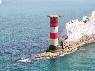 Sea canoes at base of  Needles lighthouse Isle of Wight calm day blue sky  drone , aerial , view...