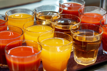 Glasses of juice on display on the table in a canteen