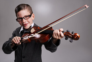 Smile, music and child with violin in studio for practice with suit and glasses for fashion. Happy,...