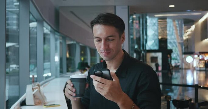 Man sitting in cafe sipping coffee phone in hand Sitting in cafe moment of respite coffee rejuvenating his spirit. While sitting in cafe thoughts wander blending relaxation with digital world.