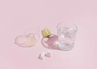 Cold lemonade, lime, sugar cubes and glassware