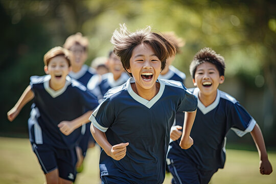 a small multicultural group of middle school korean students happily playing soccer outside on a sunny day wearing navy polos and pant