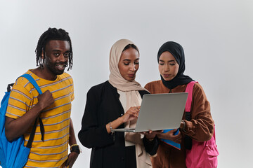 A group of students, including an African American student and two hijab-wearing women, stand...