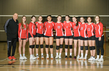 group of nice teen sport in gymnase play volleyball