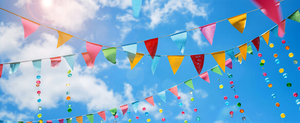 Summertime party flags over blue sky